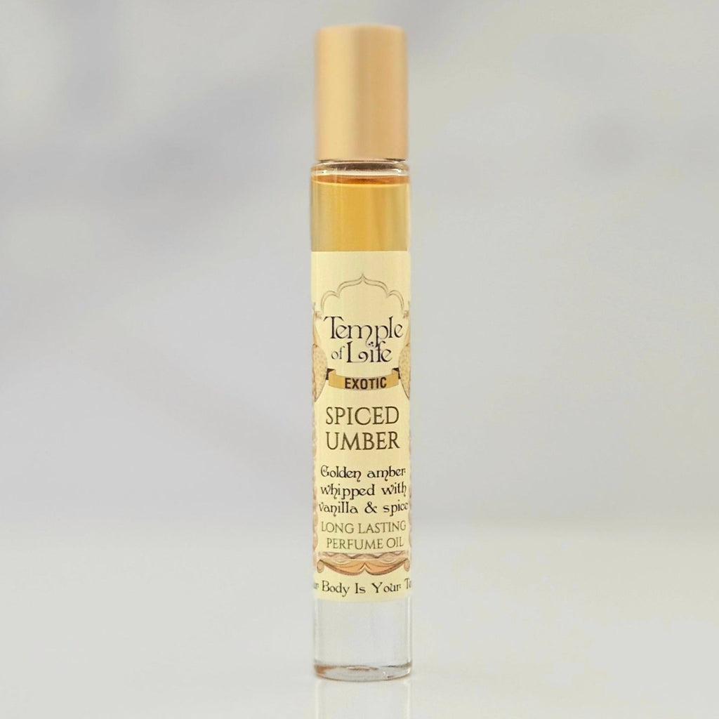 Perfume oil bottle labeled 'Temple of Life Spiced Umber' on a gray background