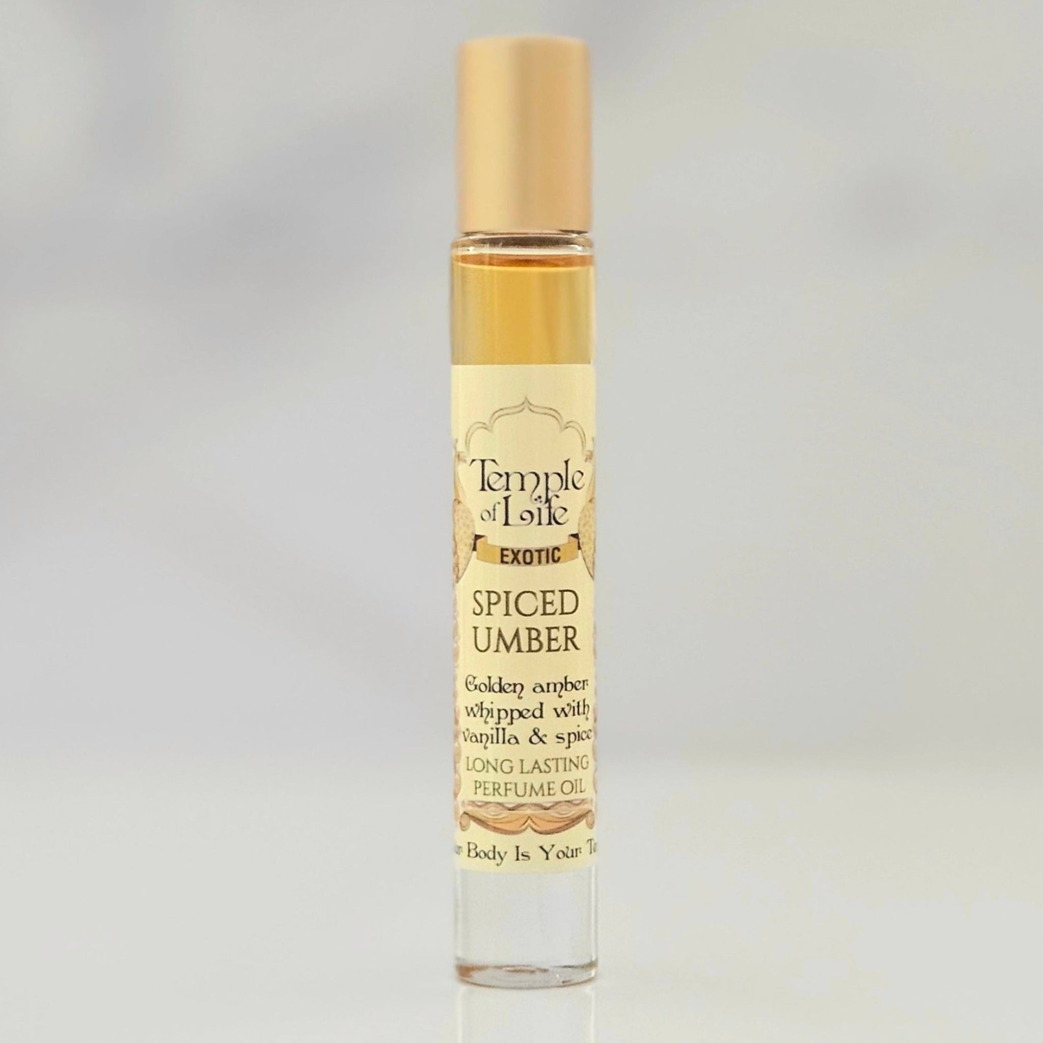 Perfume oil bottle labeled 'Temple of Life Spiced Umber' on a gray background