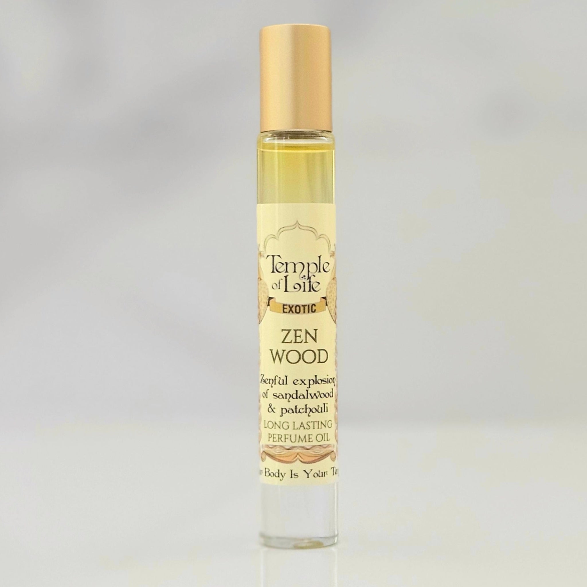 Perfume bottle labeled 'Zen Wood' by Temple of Life on a gray background