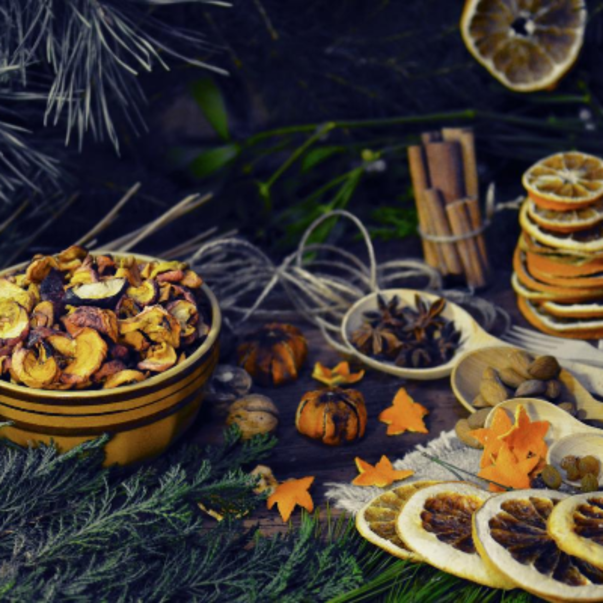 Dried fruits and spices on a dark surface with decorative elements