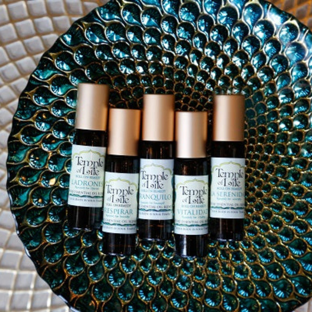 Set of Temple of Life aromatherapy products on a decorative plate with a mosaic background