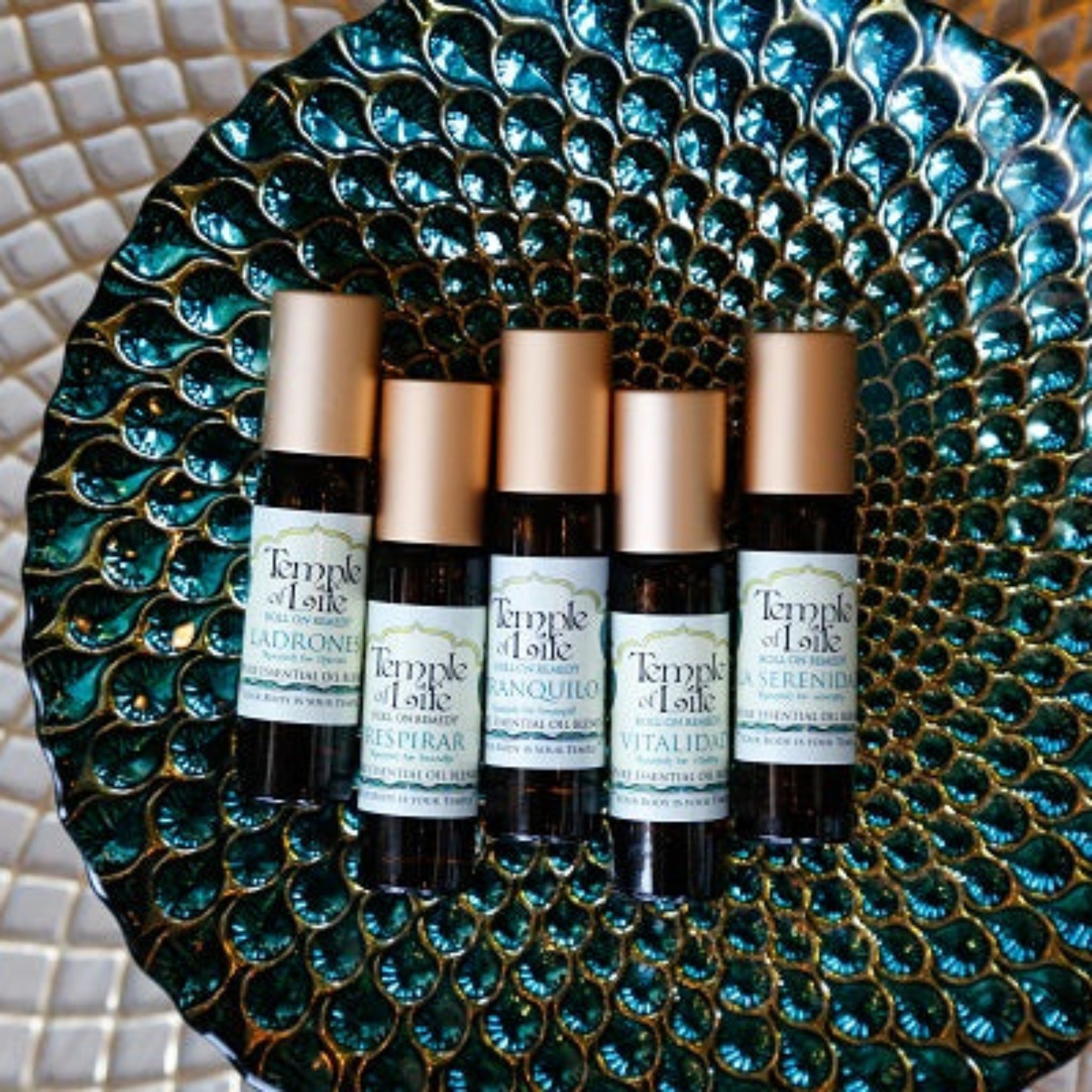 Set of Temple of Life aromatherapy products on a decorative plate with a mosaic background
