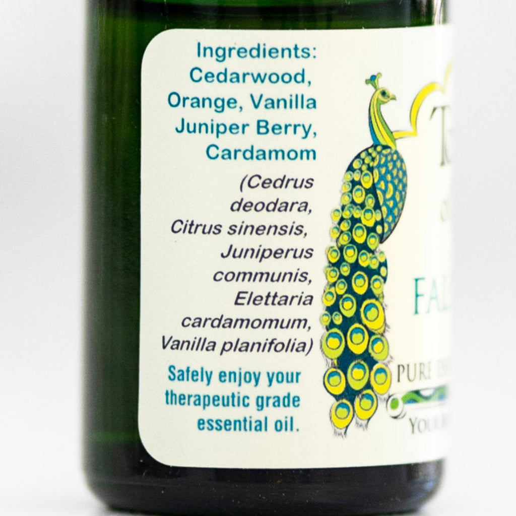 Bottle of 'Fall Arise' essential oil blend showing ingredient label.