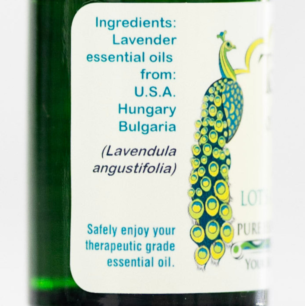 Bottle of lavender essential oil with a label detailing ingredients and safety information.
